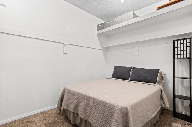 bedroom with baseboards, carpet flooring, and a textured ceiling