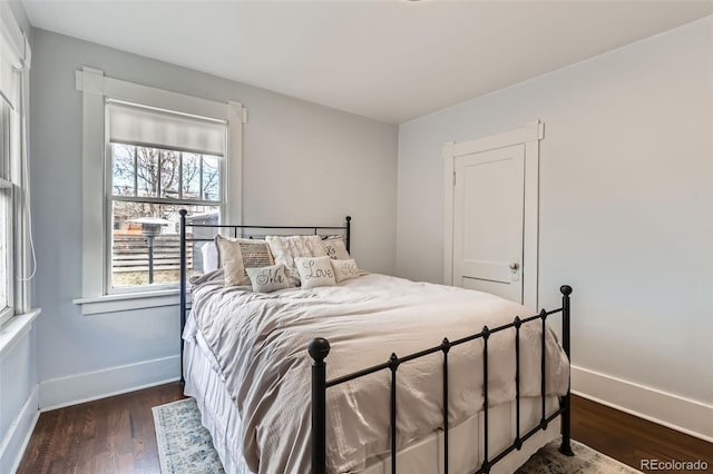 bedroom featuring wood finished floors and baseboards