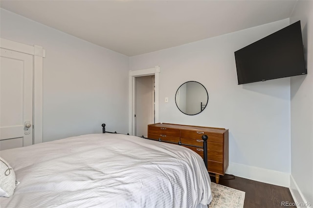 bedroom featuring baseboards and wood finished floors