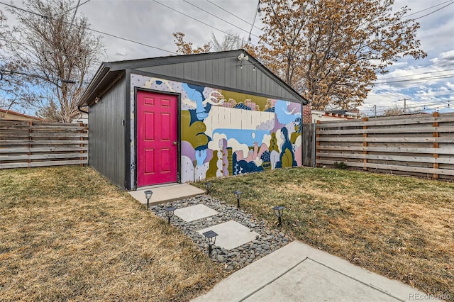 view of outbuilding featuring fence and an outdoor structure