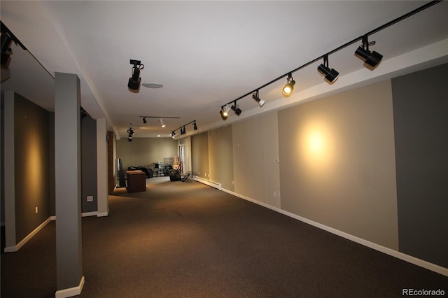 interior space with carpet, rail lighting, and a baseboard radiator