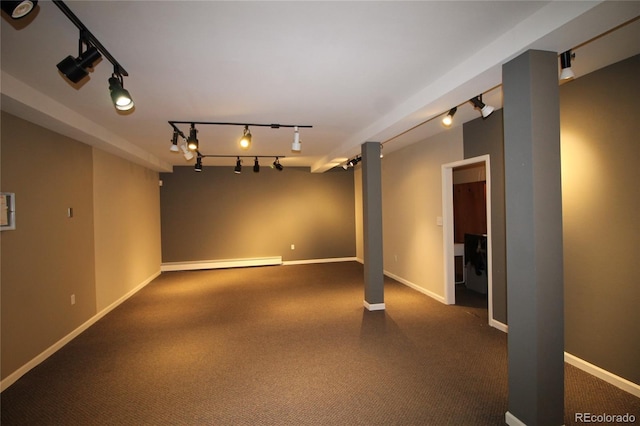 unfurnished room featuring a baseboard radiator and track lighting