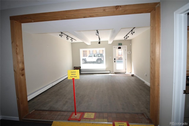 interior space featuring a baseboard radiator, hardwood / wood-style flooring, track lighting, and beamed ceiling