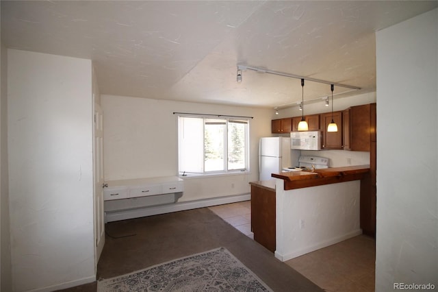 kitchen with decorative light fixtures, white appliances, a baseboard heating unit, light tile patterned floors, and kitchen peninsula