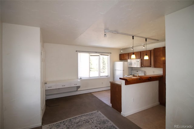 kitchen featuring decorative light fixtures, white appliances, track lighting, light tile patterned floors, and kitchen peninsula