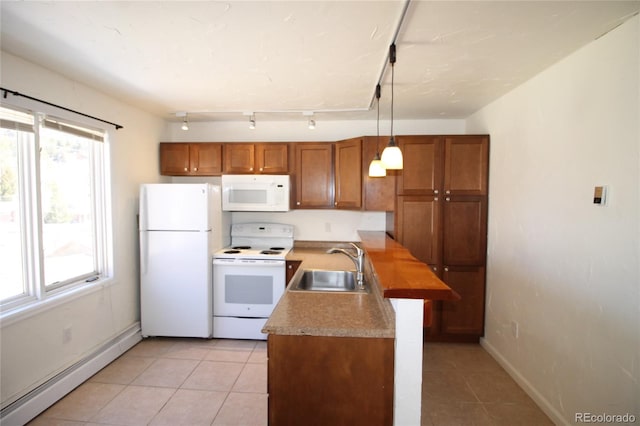 kitchen featuring a baseboard heating unit, sink, white appliances, and a healthy amount of sunlight