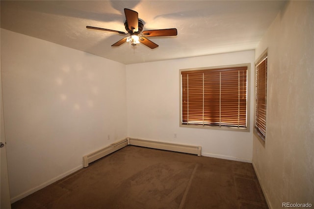 spare room with ceiling fan, dark carpet, and a baseboard radiator