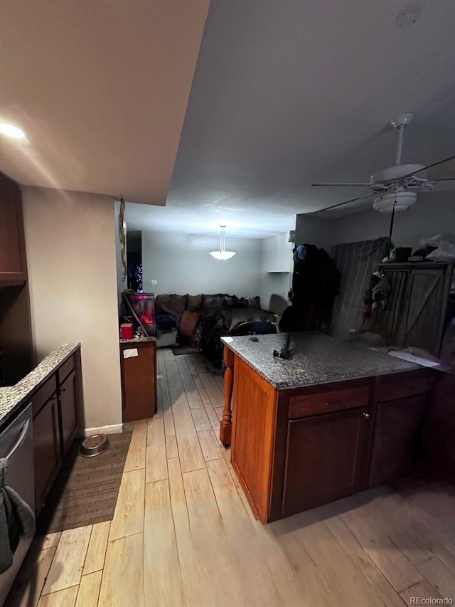 kitchen featuring kitchen peninsula, light hardwood / wood-style flooring, hanging light fixtures, and dishwasher