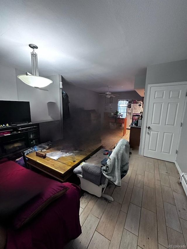 living room featuring light wood-type flooring and ceiling fan