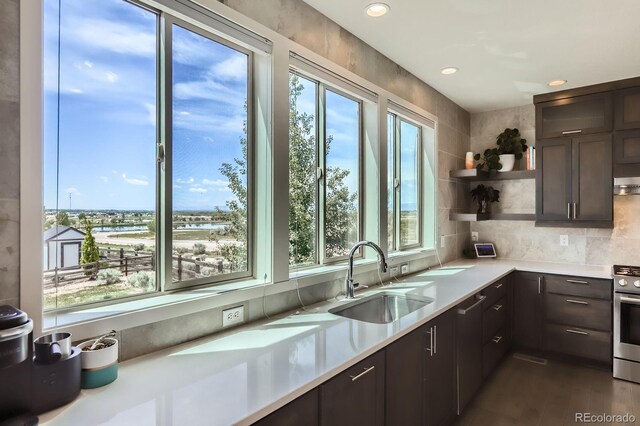 4526 Colorado River Dr, Firestone, CO 80504 - kitchen featuring a sink, light countertops, dark brown cabinetry, gas range, and recessed lighting