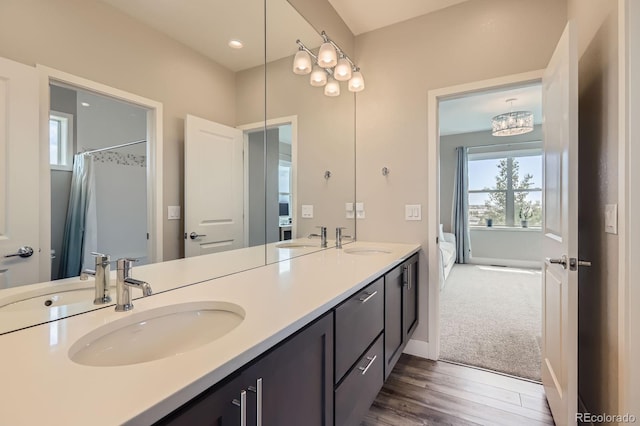 4526 Colorado River Dr, Firestone, CO 80504 - ensuite bathroom featuring double vanity, wood finished floors, and baseboards