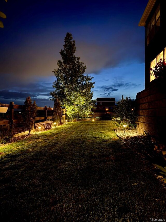 4526 Colorado River Dr, Firestone, CO 80504 - yard at dusk with a lawn