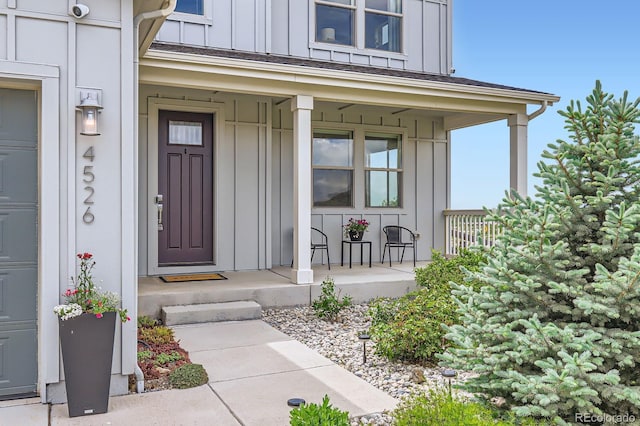 4526 Colorado River Dr, Firestone, CO 80504 - property entrance with board and batten siding, a porch, and a security system