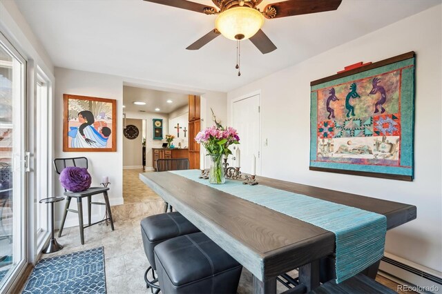 dining room featuring baseboard heating and ceiling fan