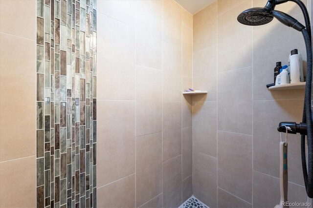 bathroom with tiled shower