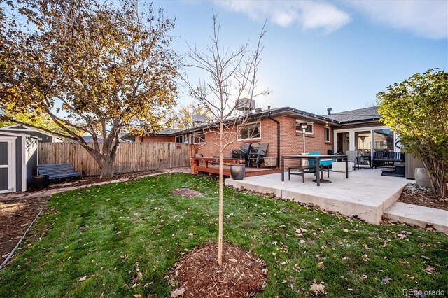 view of yard with a storage shed and a patio area