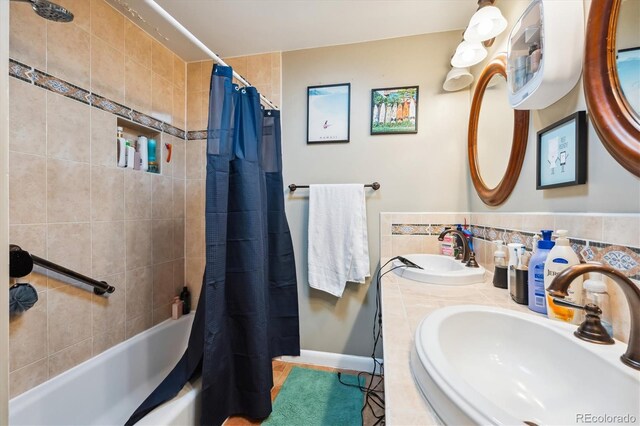 bathroom with shower / bath combination with curtain and vanity