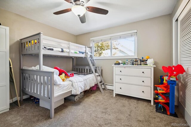 carpeted bedroom featuring ceiling fan and baseboard heating