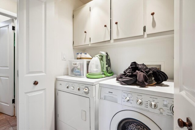 washroom with cabinets and separate washer and dryer