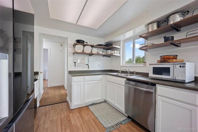 7118 Metropolitan St, Colorado Springs, CO 80911 - kitchen with open shelves, dishwasher, a sink, white microwave, and light wood-style floors