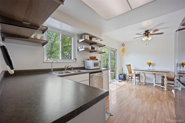 7118 Metropolitan St, Colorado Springs, CO 80911 - kitchen featuring open shelves, dark countertops, a sink, and white microwave