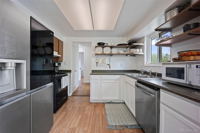 7118 Metropolitan St, Colorado Springs, CO 80911 - kitchen featuring black electric range, stainless steel dishwasher, open shelves, a sink, and white microwave
