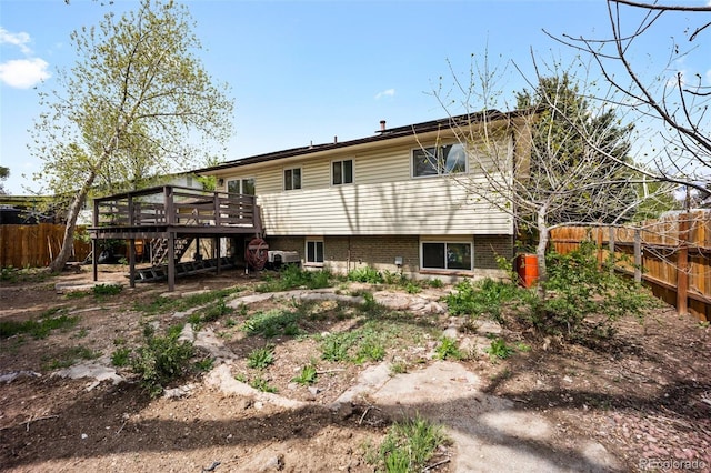 7118 Metropolitan St, Colorado Springs, CO 80911 - rear view of house featuring fence, a deck, and stairway