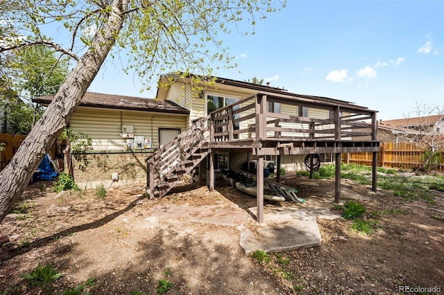 7118 Metropolitan St, Colorado Springs, CO 80911 - back of house with brick siding, fence, a wooden deck, and stairs