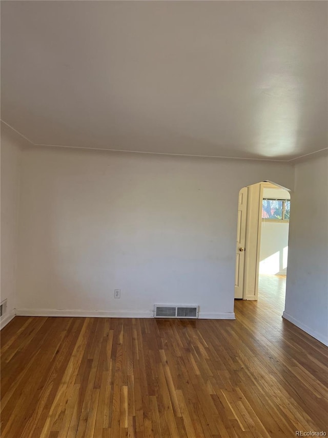 empty room with hardwood / wood-style flooring