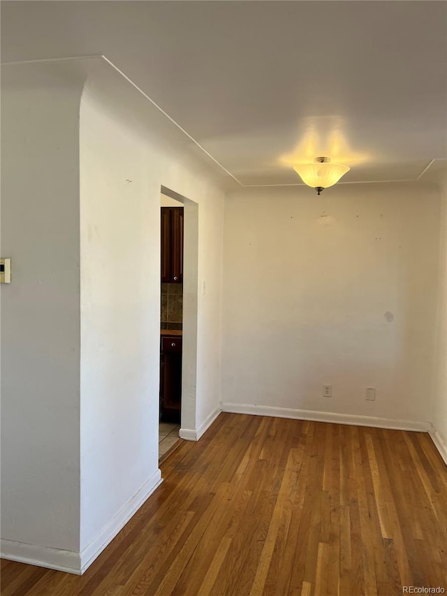 unfurnished room with hardwood / wood-style floors