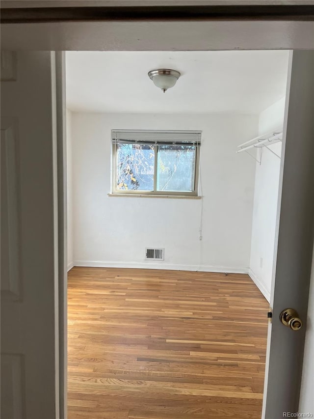 unfurnished room with light hardwood / wood-style flooring