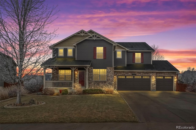 craftsman inspired home featuring a lawn, a porch, and a garage