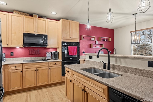 kitchen featuring sink, light brown cabinets, pendant lighting, black appliances, and light wood-type flooring