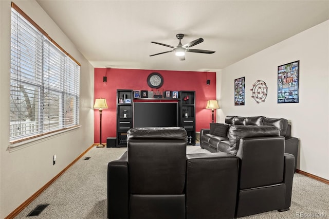 carpeted home theater featuring ceiling fan