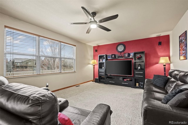 carpeted living room featuring a wealth of natural light and ceiling fan