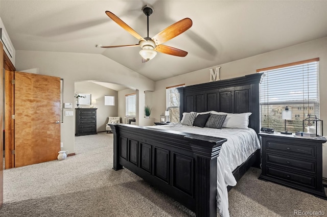 bedroom with multiple windows, ceiling fan, light colored carpet, and vaulted ceiling