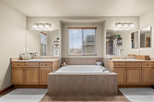 bathroom featuring tile patterned floors, vanity, a textured ceiling, and separate shower and tub