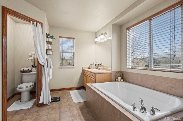 bathroom featuring tile patterned floors, vanity, a relaxing tiled tub, and toilet