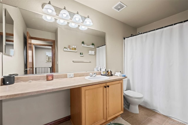 bathroom featuring tile patterned floors, vanity, and toilet