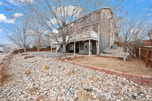 back of property with central air condition unit and a patio area