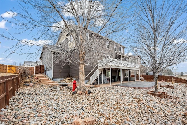 back of house with a deck and a patio area