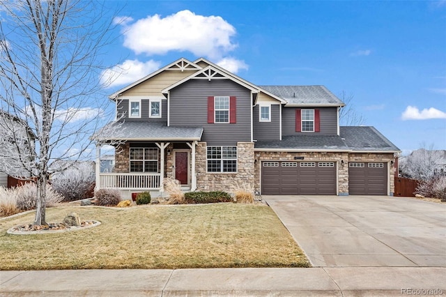 craftsman house with a front yard, a porch, and a garage