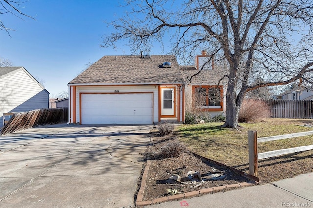 view of front of property featuring a garage and a front lawn