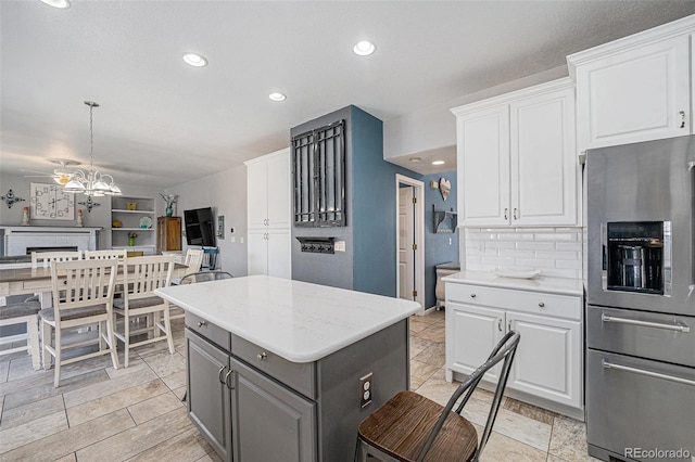5224 Snow Goose St, Brighton, CO 80601 - kitchen with a kitchen island, white cabinets, open floor plan, gray cabinets, and stainless steel fridge