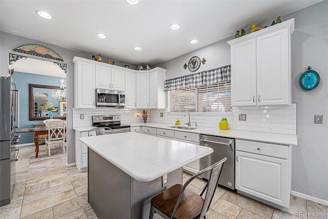 5224 Snow Goose St, Brighton, CO 80601 - kitchen featuring white cabinets, appliances with stainless steel finishes, a sink, light countertops, and backsplash