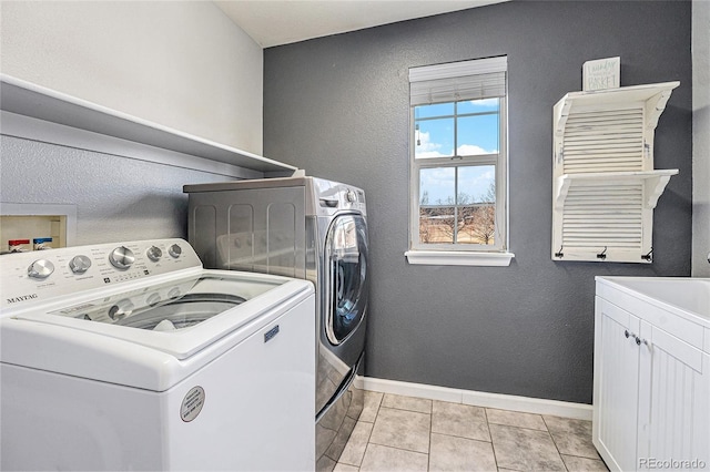 5224 Snow Goose St, Brighton, CO 80601 - laundry room with separate washer and dryer, light tile patterned flooring, cabinet space, and baseboards