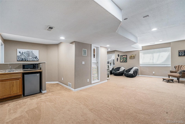 5224 Snow Goose St, Brighton, CO 80601 - interior space featuring light carpet, open floor plan, stainless steel microwave, and visible vents