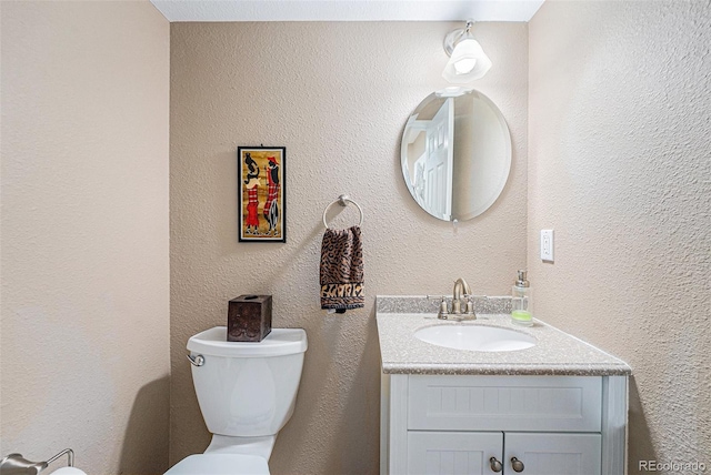 5224 Snow Goose St, Brighton, CO 80601 - half bath with toilet, a textured wall, and vanity