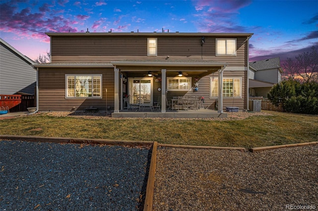 5224 Snow Goose St, Brighton, CO 80601 - rear view of property featuring a lawn, a ceiling fan, a patio area, fence, and central AC