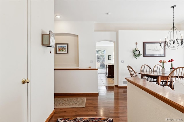 interior space with a chandelier and hardwood / wood-style flooring